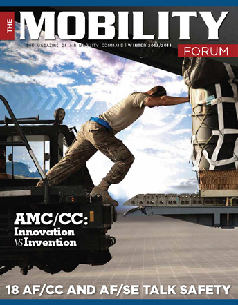 Standing on the front of a truck, a person in fatigues pushes netted cargo into a bay door on the cover of an issue of The Mobility Forum magazine published for Air Mobility Command.  