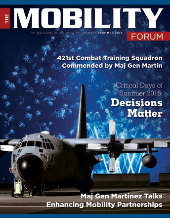 Blue fireworks and a jet on the ground on the cover of an issue of The Mobility Forum magazine published for Air Mobility Command.  