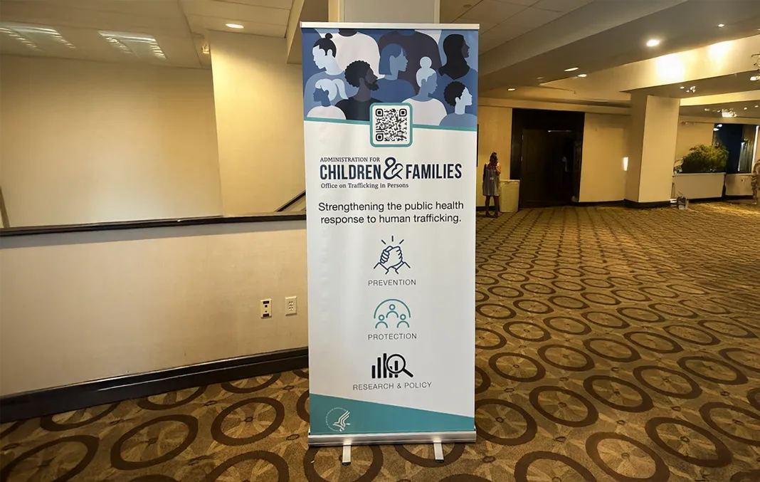Retractable banner display for the Office on Trafficking in Persons: Administration for Children & Families showing the tagline 'Strengthening the public health response to human trafficking' as well as the top three items of focus: prevention, protection, and research & policy.